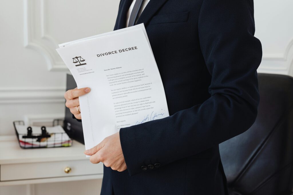 A person holding a divorce decree in an office setting, symbolizing legal proceedings.